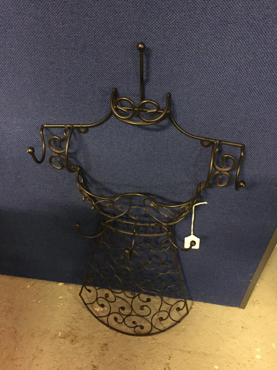 A WALL MOUNTED DRESS SHAPED ACCESSORIES HOOK