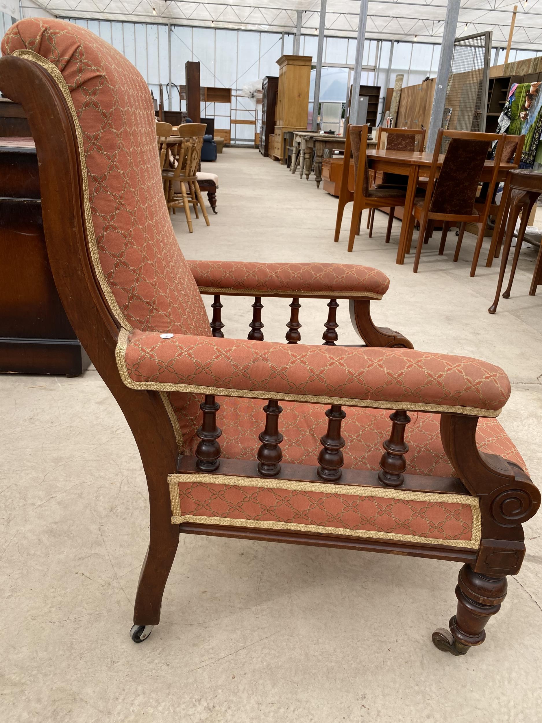 A VICTORIAN MAHOGANY FIRESIDE CHAIR WITH TURNED UPRIGHTS AND FRONT LEGS WITH LATER STOOL HAVING - Image 3 of 6