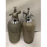 TWO VINTAGE SODA SYPHONS WITH WIRE MESH COVERING MADE IN ENGLAND