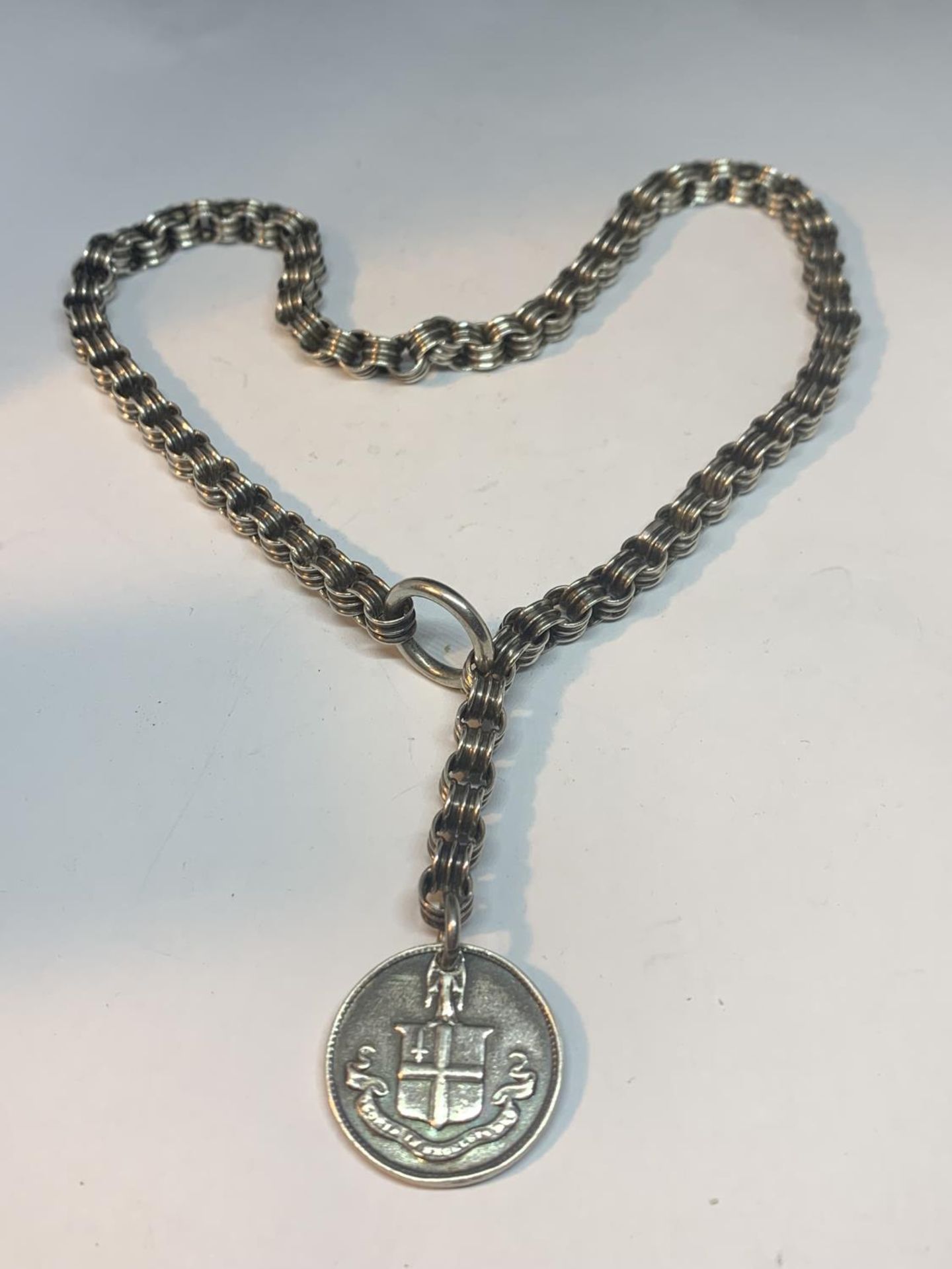 A SILVER NECKLACE WITH FOB