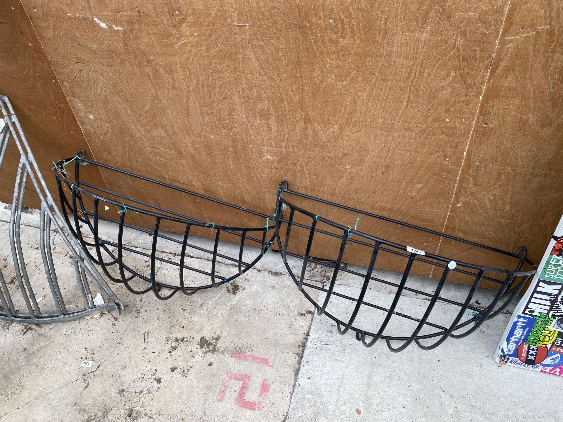 A PAIR OF WROUGHT IRON WALL HANGING HAY RACKS