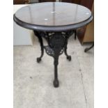 A VICTORIAN CAST IRON PUB TABLE WITH PIERCED UNDERSHELF AND OAK TOP, 24" DIAMETER