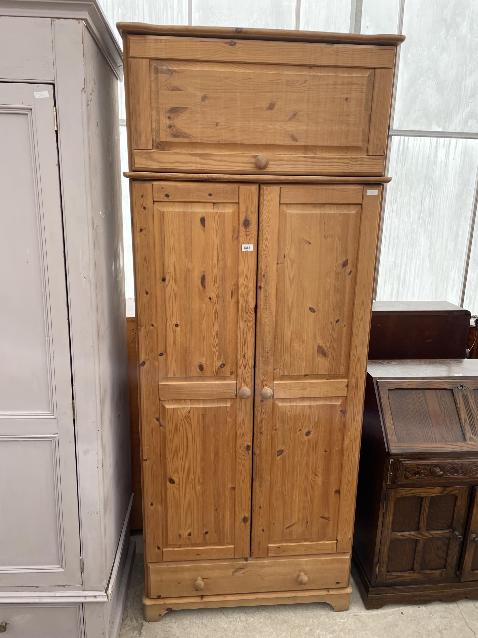 A MODERN PINE TWO DOOR WARDROBE WITH A DRAWER TO THE BASE AND TOP BOX 35" WIDE