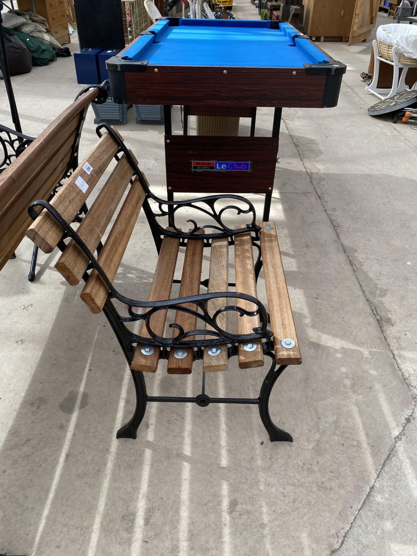 A WOODEN SLATTED GARDEN CHAIR WITH CAST IRON ENDS - Image 2 of 2