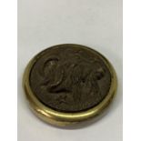 A BRASS PAPERWEIGHT WITH A RAMS HEAD DECORATION
