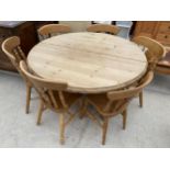 A 50" DIAMETER PINE KITCHEN TABLE AND EXTRA LEAF (17") AND SIX CHAIRS