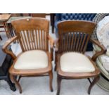 TWO EARLY 20TH CENTURY OAK AND BEECH OFFICE ELBOW CHAIRS