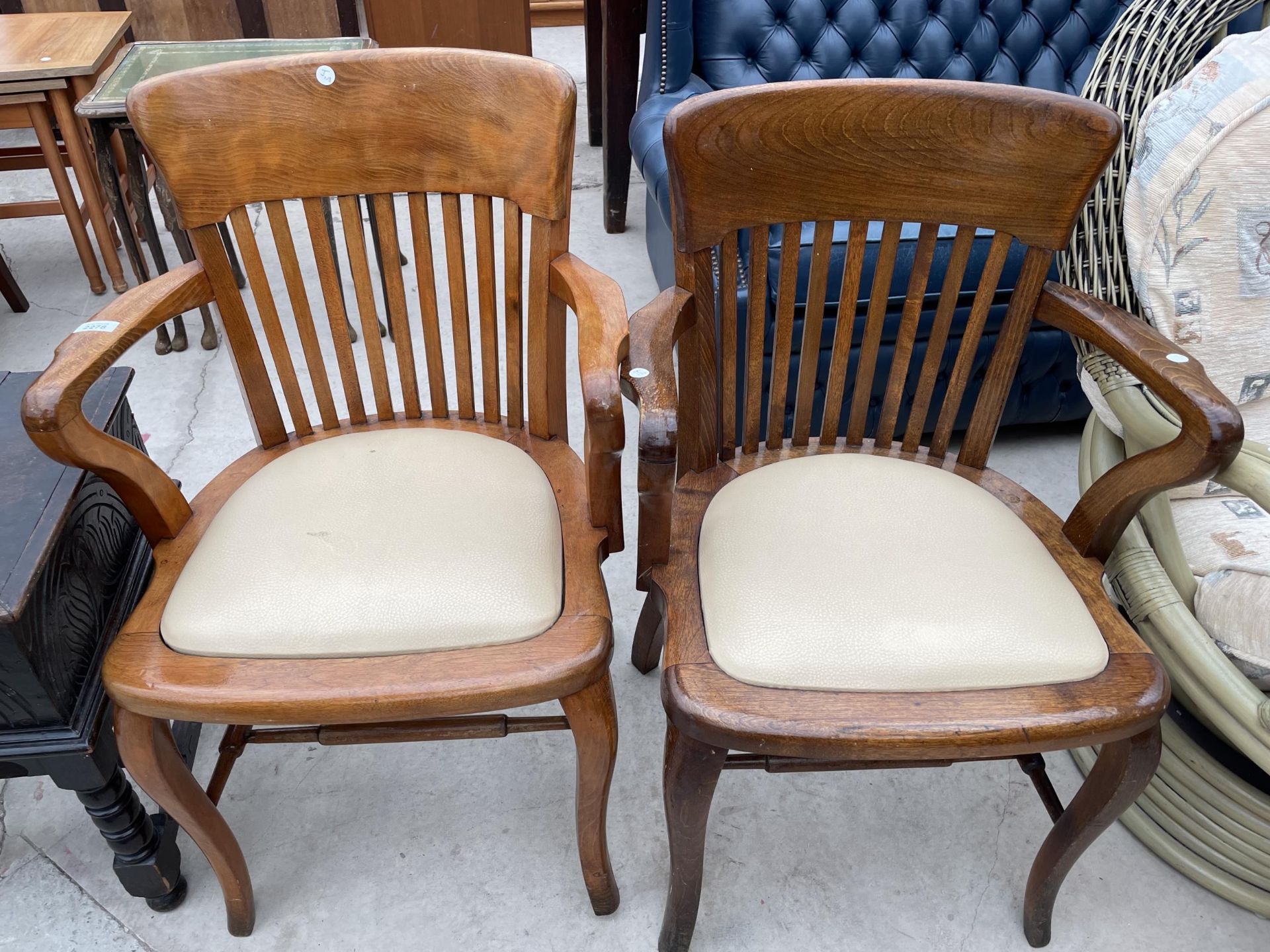 TWO EARLY 20TH CENTURY OAK AND BEECH OFFICE ELBOW CHAIRS