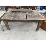 A VICTORIAN SCRUB-TOP WIND OUT DINING TABLE ON TURNED AND FLUTED LEGS