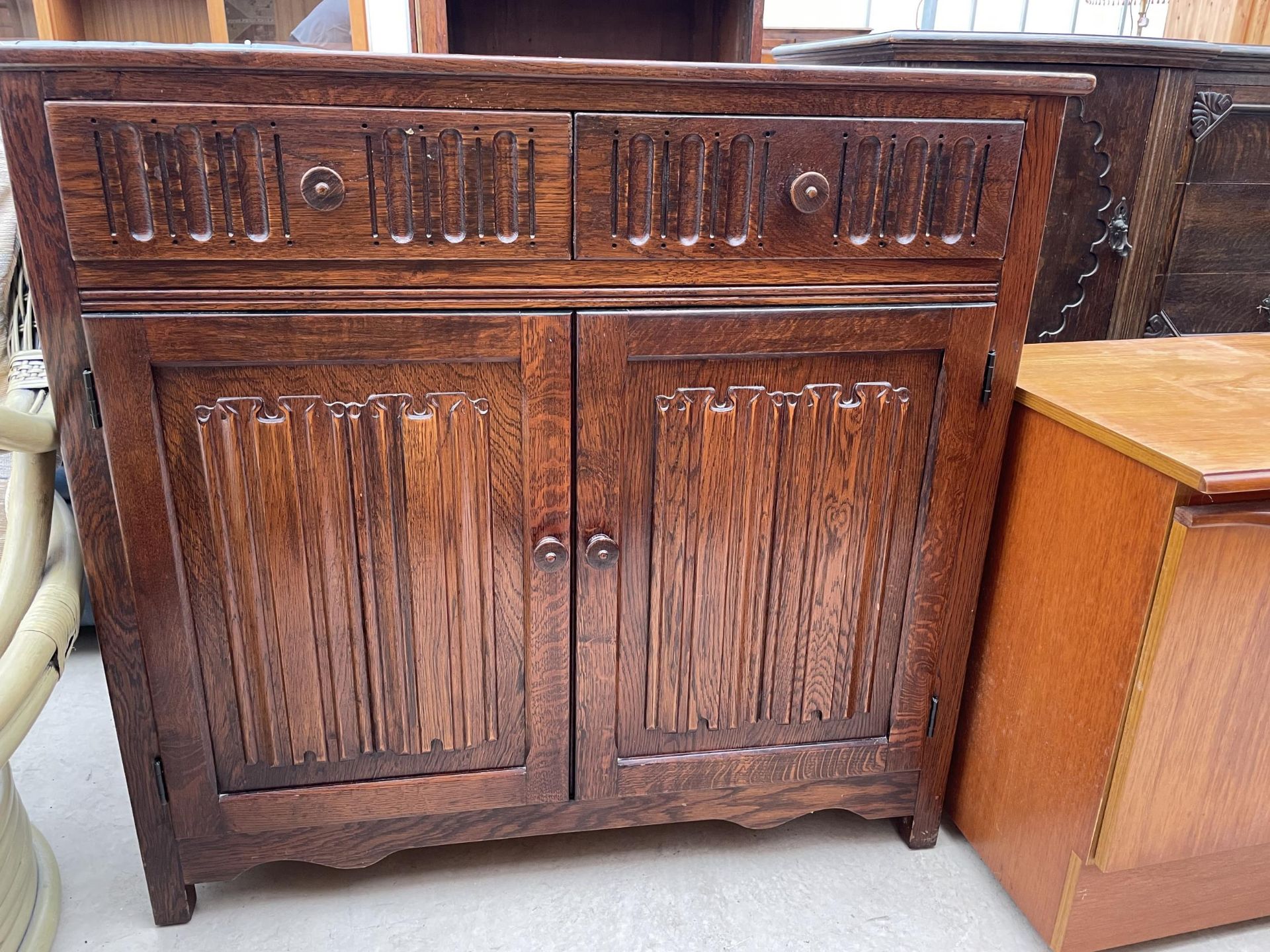 AN OAK OLD CHARM STYLE DRESSER BASE WITH LINEN FOLD DOORS 37.5" WIDE - Image 2 of 3