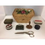 A SMALL VINTAGE SEWING BASKET CONTAINING VARIOUS SEWING ITEMS AND VINTAGE TINS