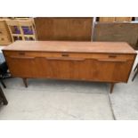 A RETRO TEAK SIDEBOARD ENCLOSING THREE DRAWERS, TWO SIDE CUPBOARDS AND ONE CENTRAL CUPBOARD WITH