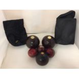 A SET OF LIGNUM VITAE BOWLING BALLS AND CRICKET BALLS