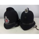 A GREATER MANCHESTER POLICE HELMET AND ANOTHER HELMET