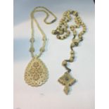 TWO CARVED BONE NECKLACES ONE WITH LARGE FOB AND ONE WITH A CROSS DESIGN