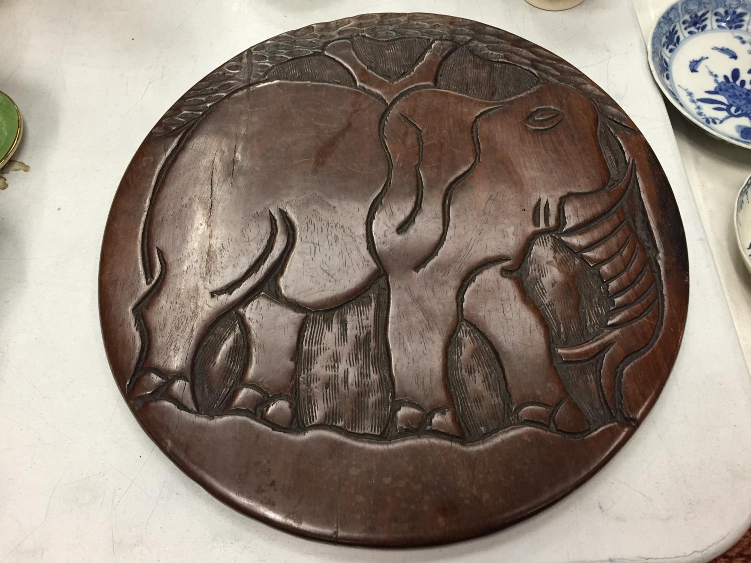 A WOODEN CARVED TRIBAL PLAQUE DEPICTING AN ELEPHANT