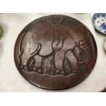 A WOODEN CARVED TRIBAL PLAQUE DEPICTING AN ELEPHANT