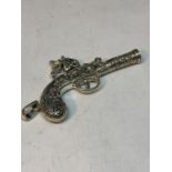 A PENDANT IN THE FORM OF AN ORNATE PISTOL