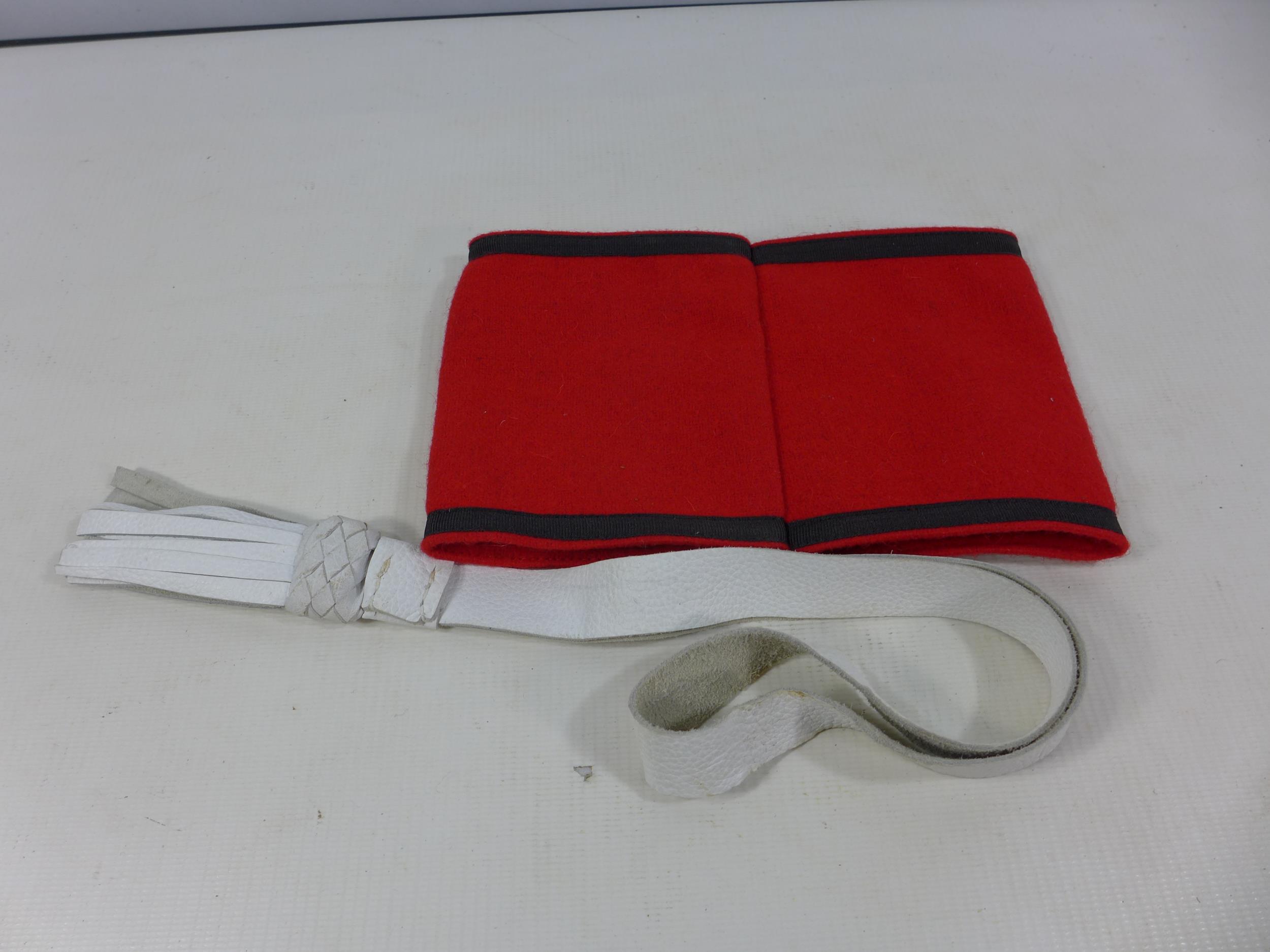 A NAZI ARM BAND AND A WHITE LEATHER TASSLE (2) - Image 2 of 3