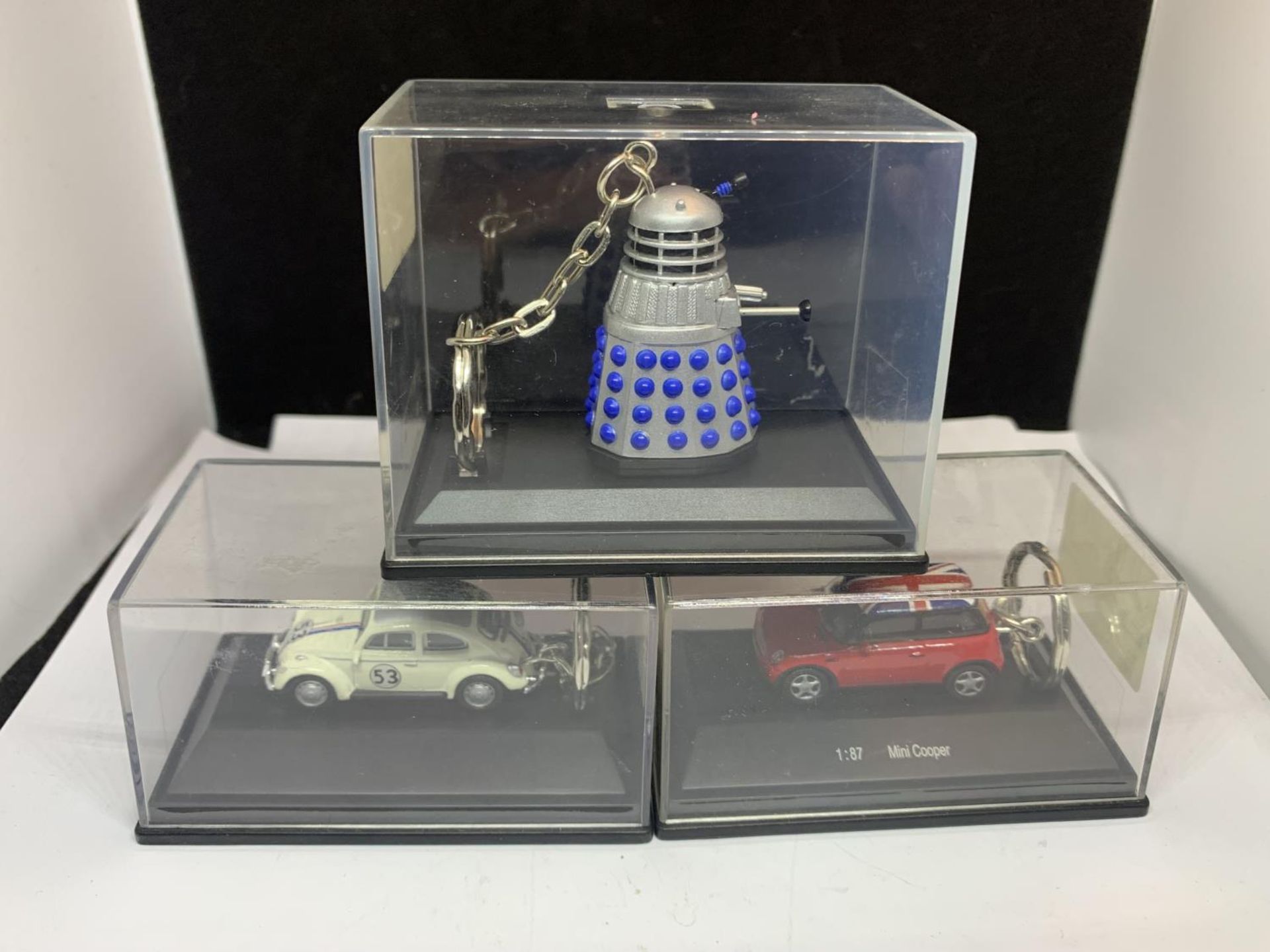 THREE BOXED KEYRINGS TO INCLUDE A DALEK, MINI COOPER AND BEETLE