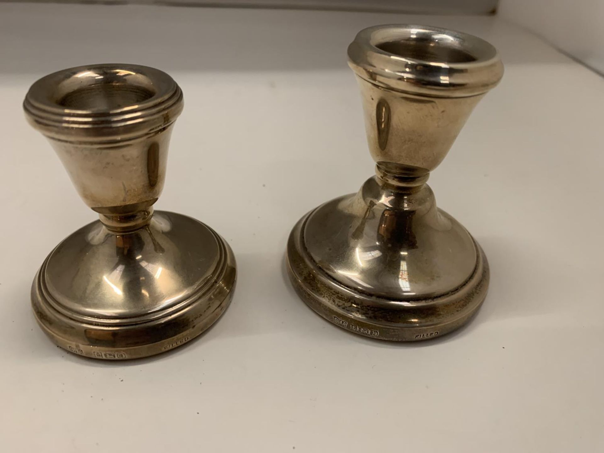 TWO HALLMARKED BIRMINGHAM SILVER WEIGHTED CANDLESTICK HOLDERS APPROXIMATELY 7CM HIGH - Image 2 of 4