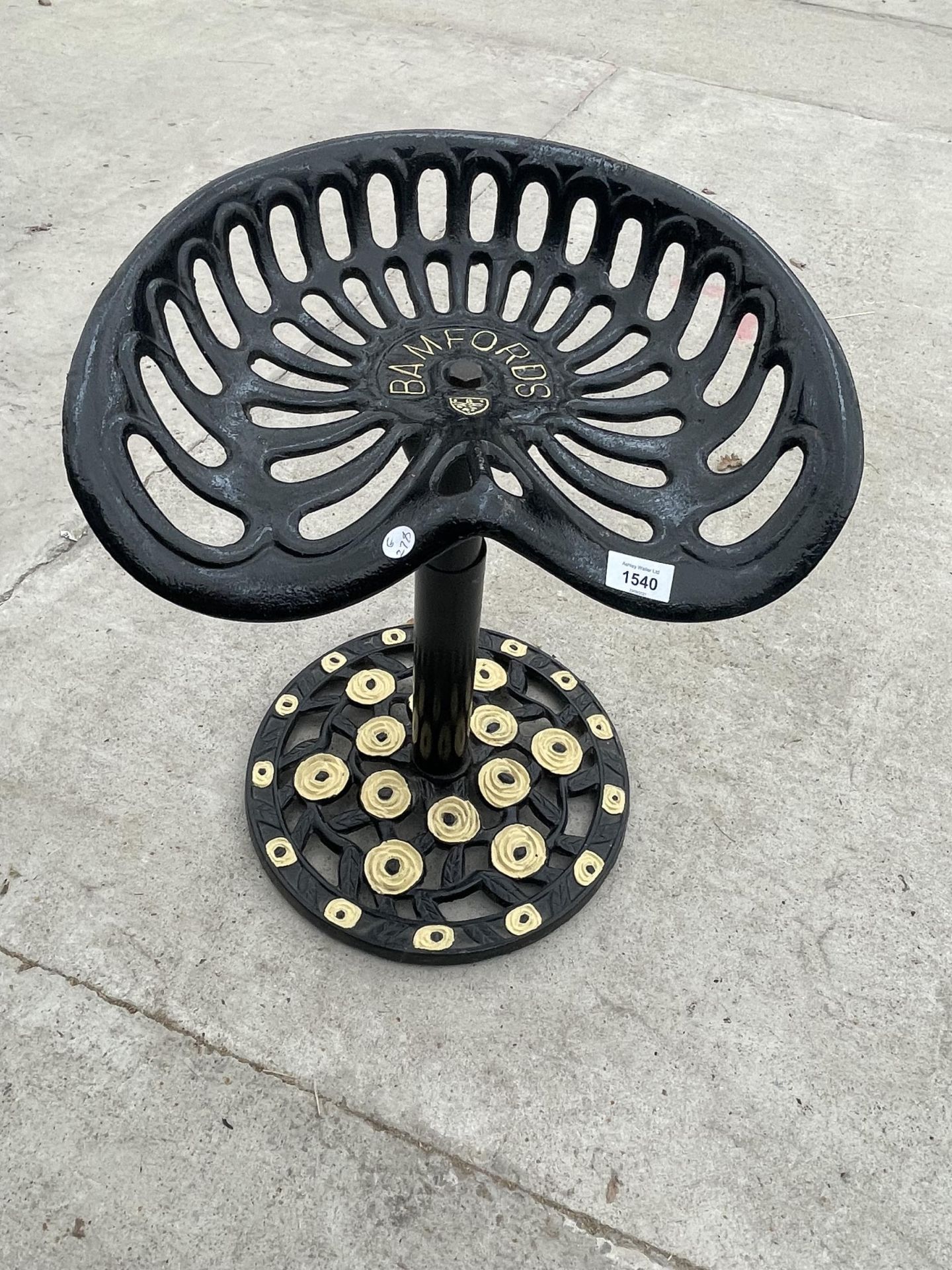 A BAR STOOL CREATED FROM A REFURBISHED BAMFORDS TRACTOR SEAT