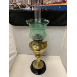 A VINTAGE BRASS OIL LAMP WITH GREEN GLASS SHADE AND FUNNEL
