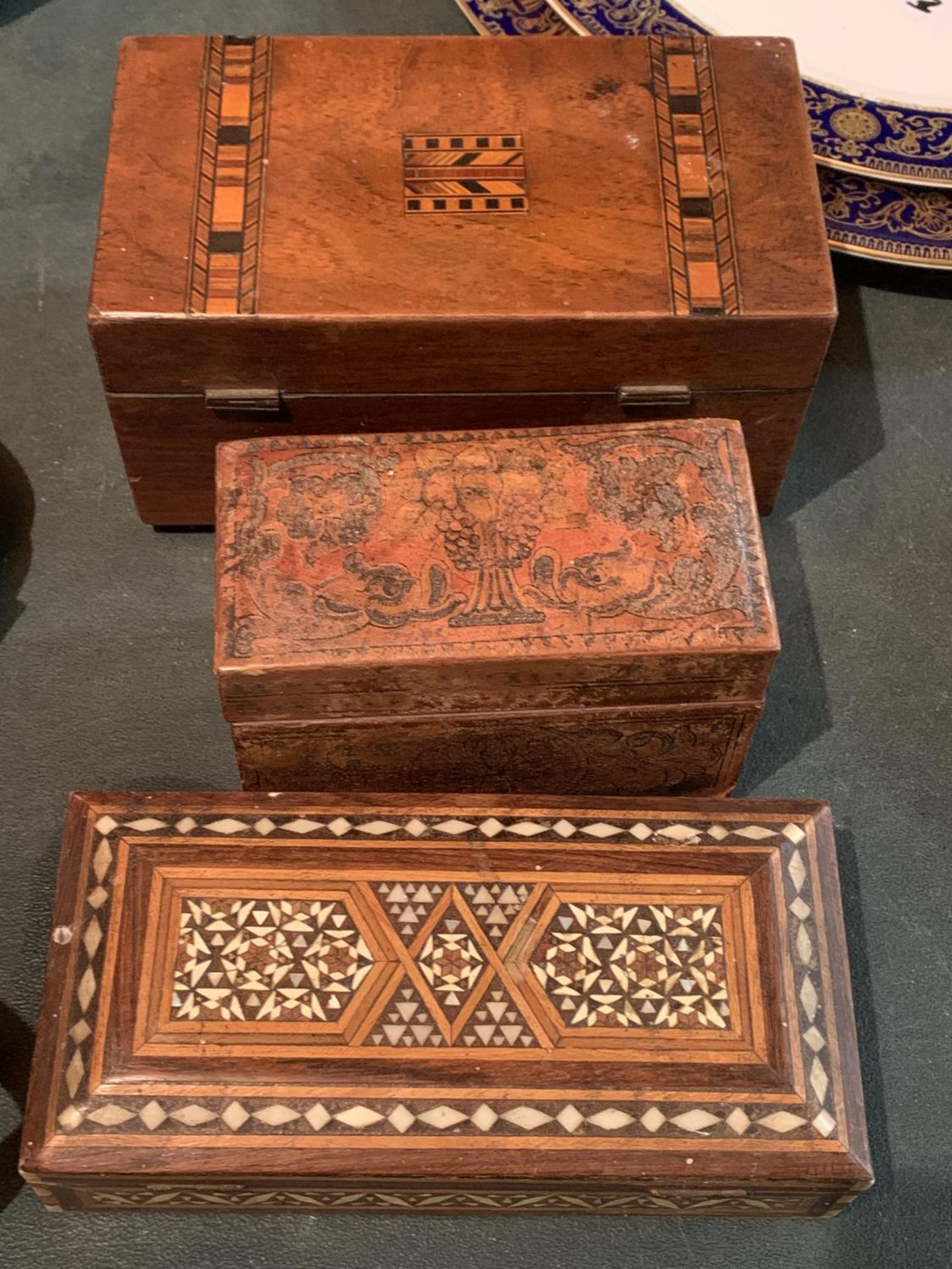 THREE TREEN LIDDED BOXES TO INCLUDE A CIGARETTE BOX AND A TEA CADDY