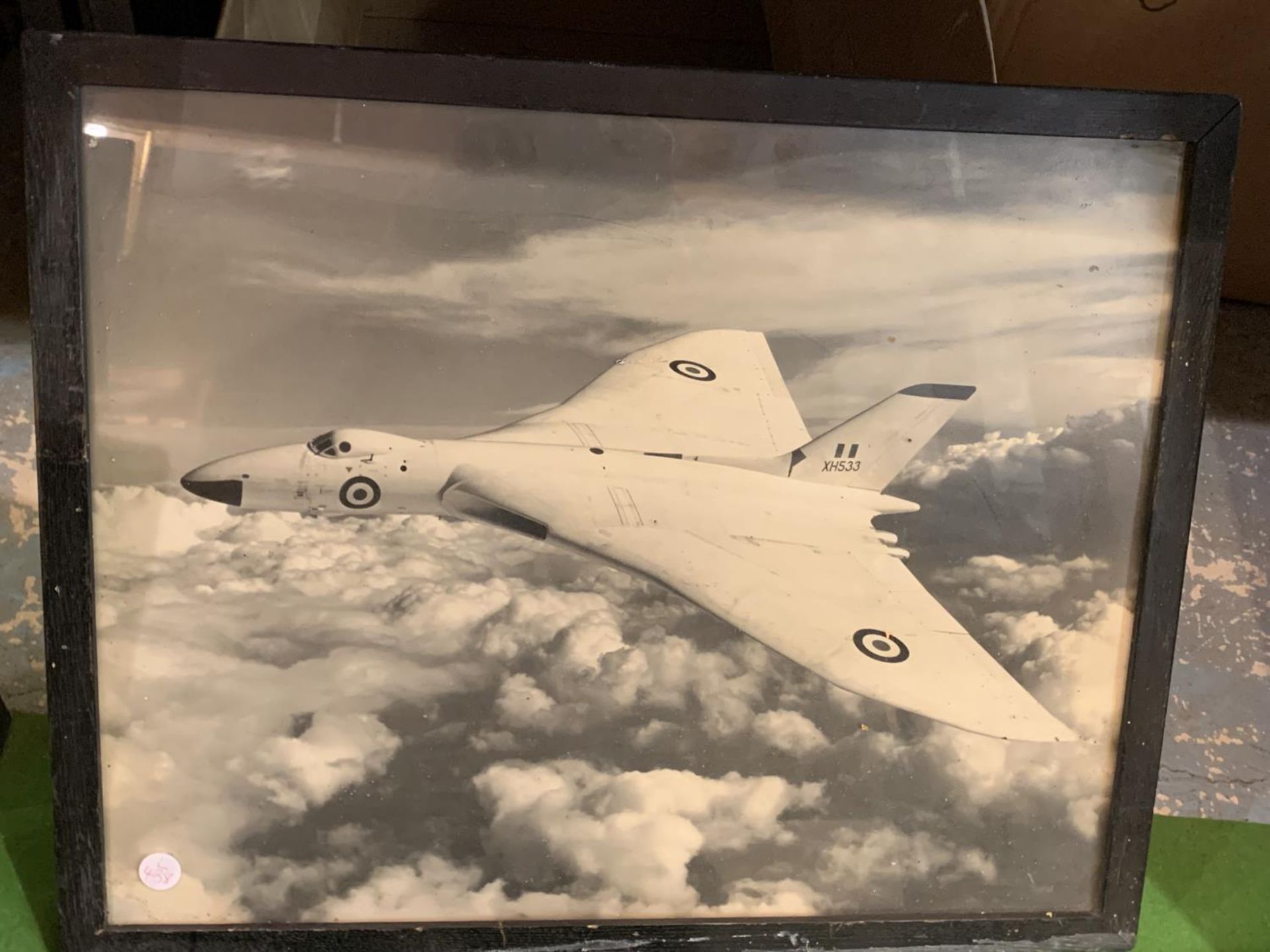 A FRAMED PHOTOGRAPH OF AN AIRCRAFT IN FLIGHT