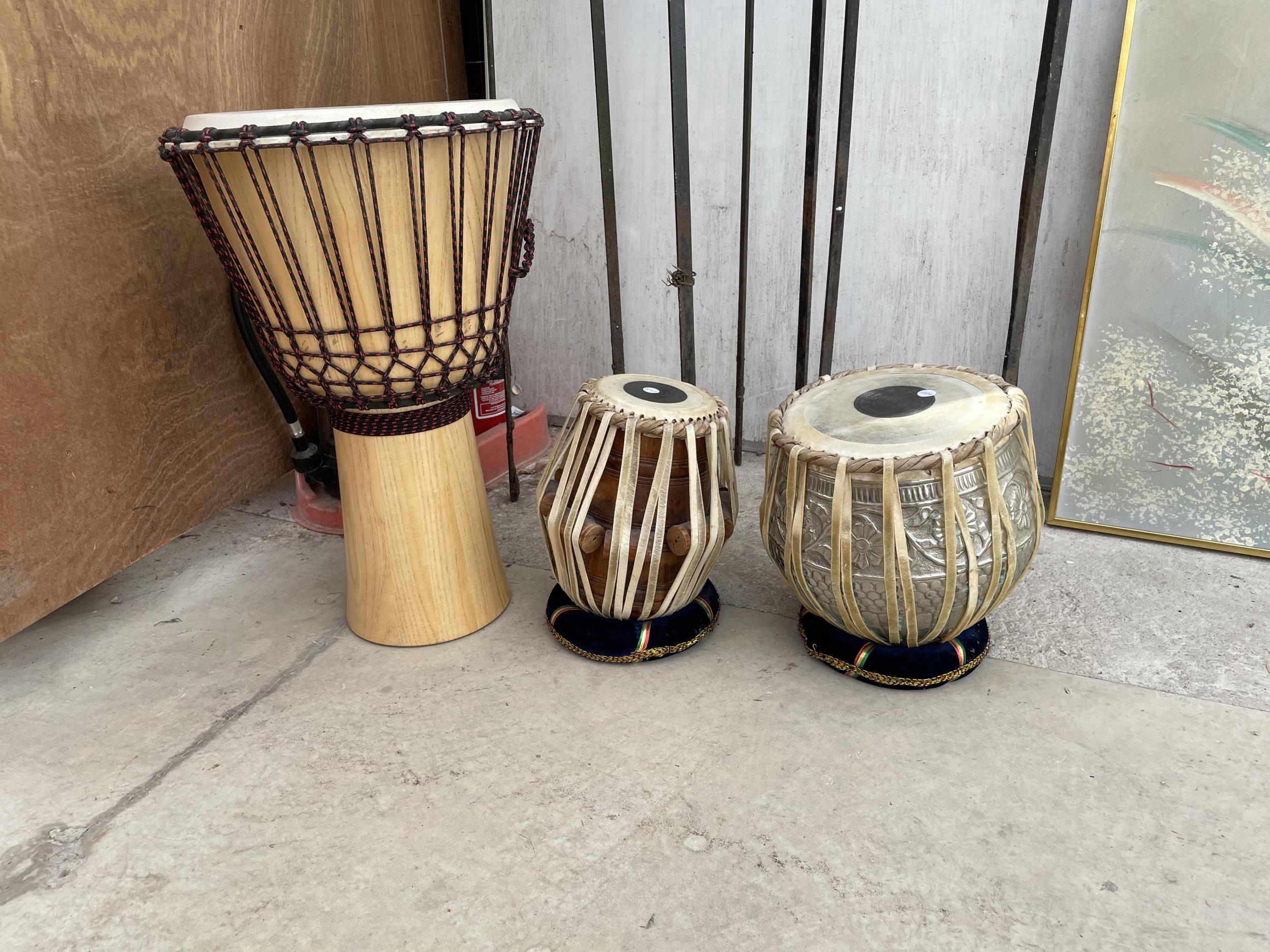A LARGE DRUM AND TWO FURTHER DRUMS