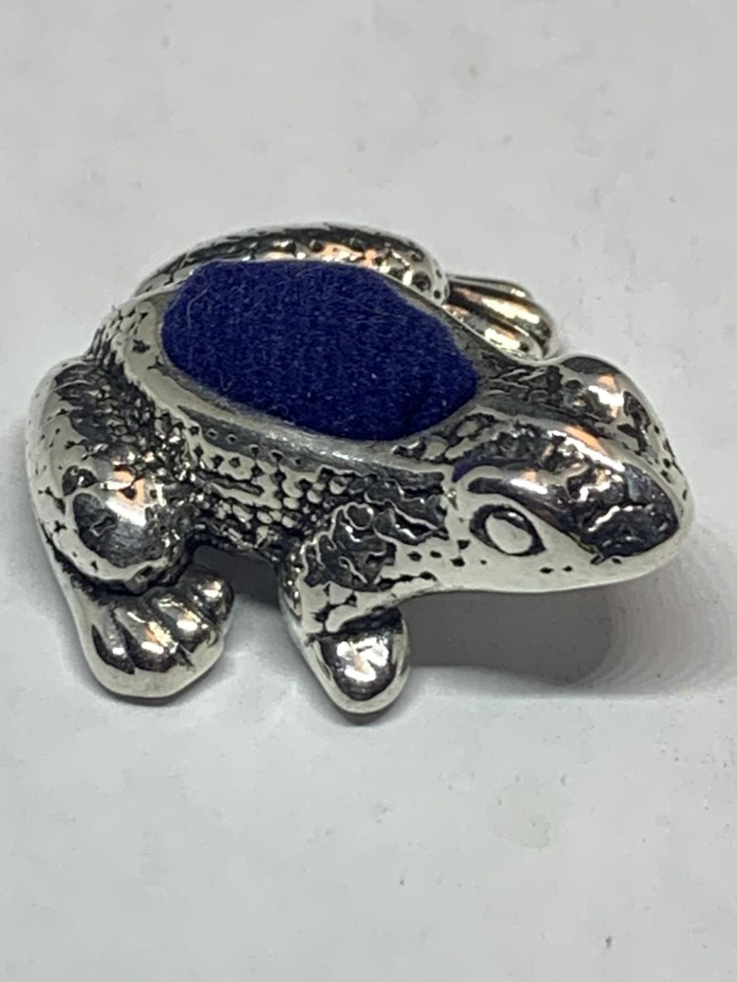 A MARKED SILVER FROG PIN CUSHION
