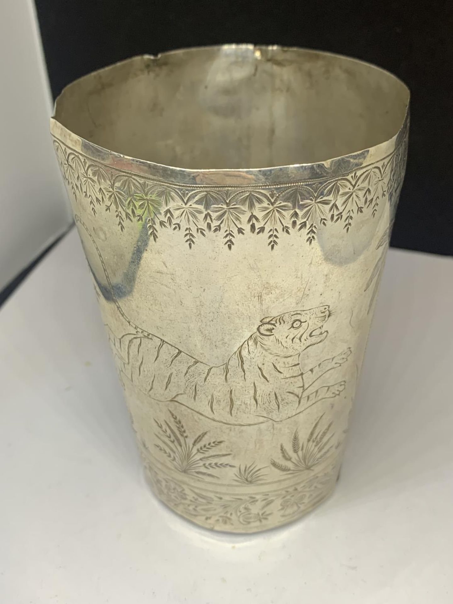 AN INDIAN, TESTED SILVER BEAKER WITH ENGRAVINGS DEPICTING A TIGER HUNTING MUNTJAC DEER, HEIGHT 10.