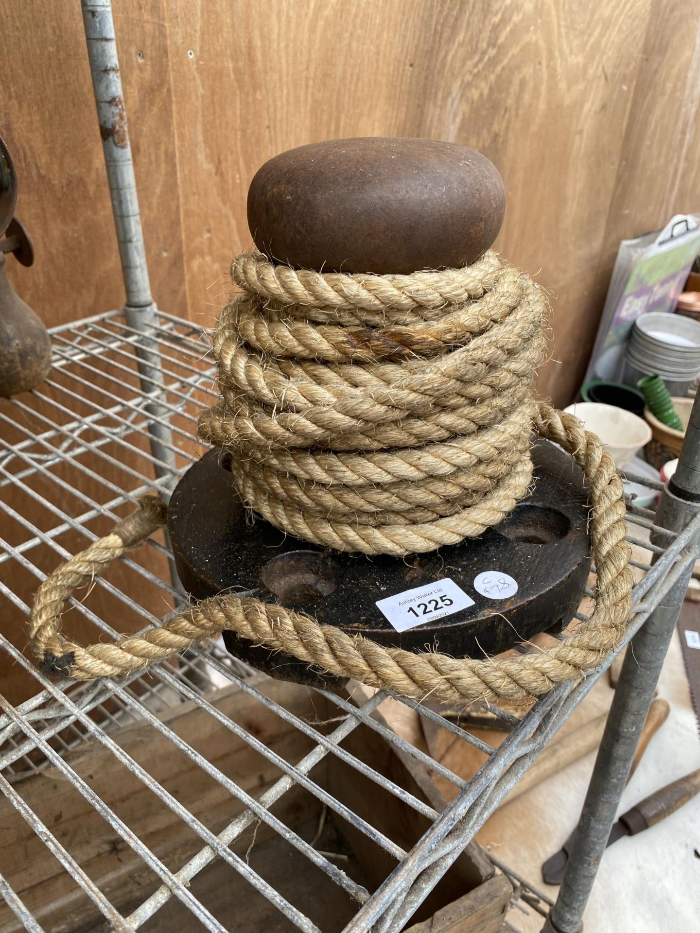 A VINTAGE BOAT CAPSTAN WITH ROPE