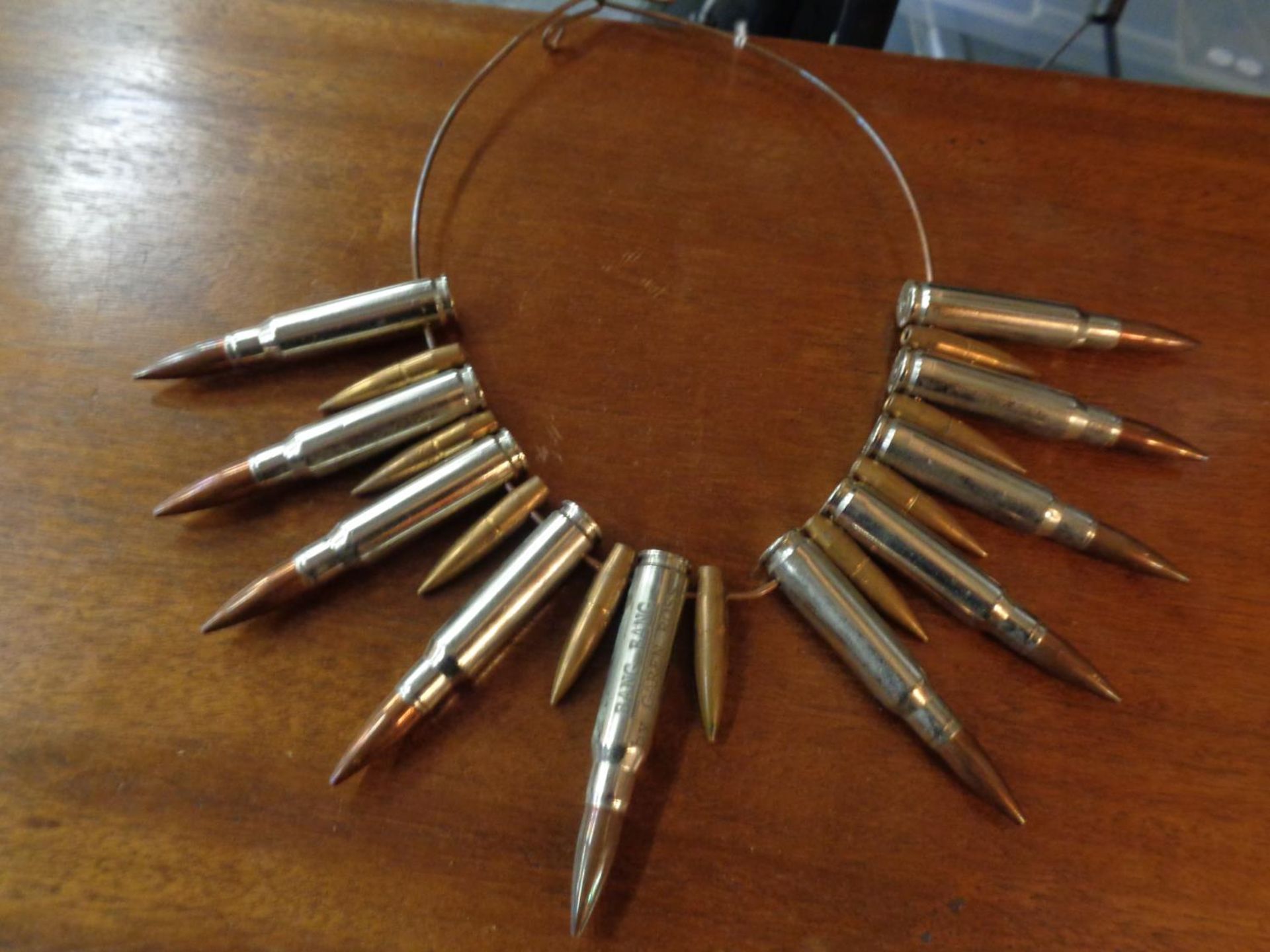 A NECKLACE MADE OF BULLETS STAMPED 'BANG BANG BY CAREN ROSS'