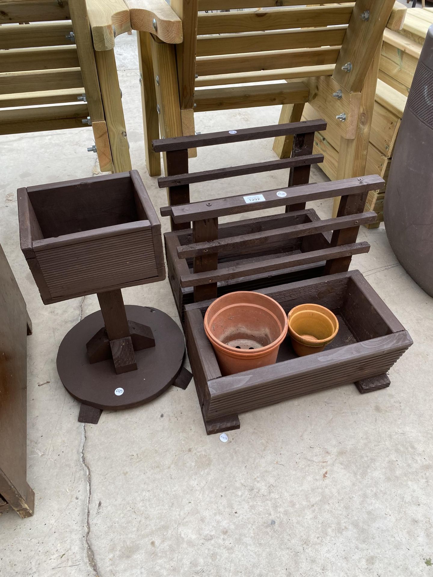 A PAIR OF WOODEN PLANTER TROUGHS AND A FURTHER WOODEN PLANTER