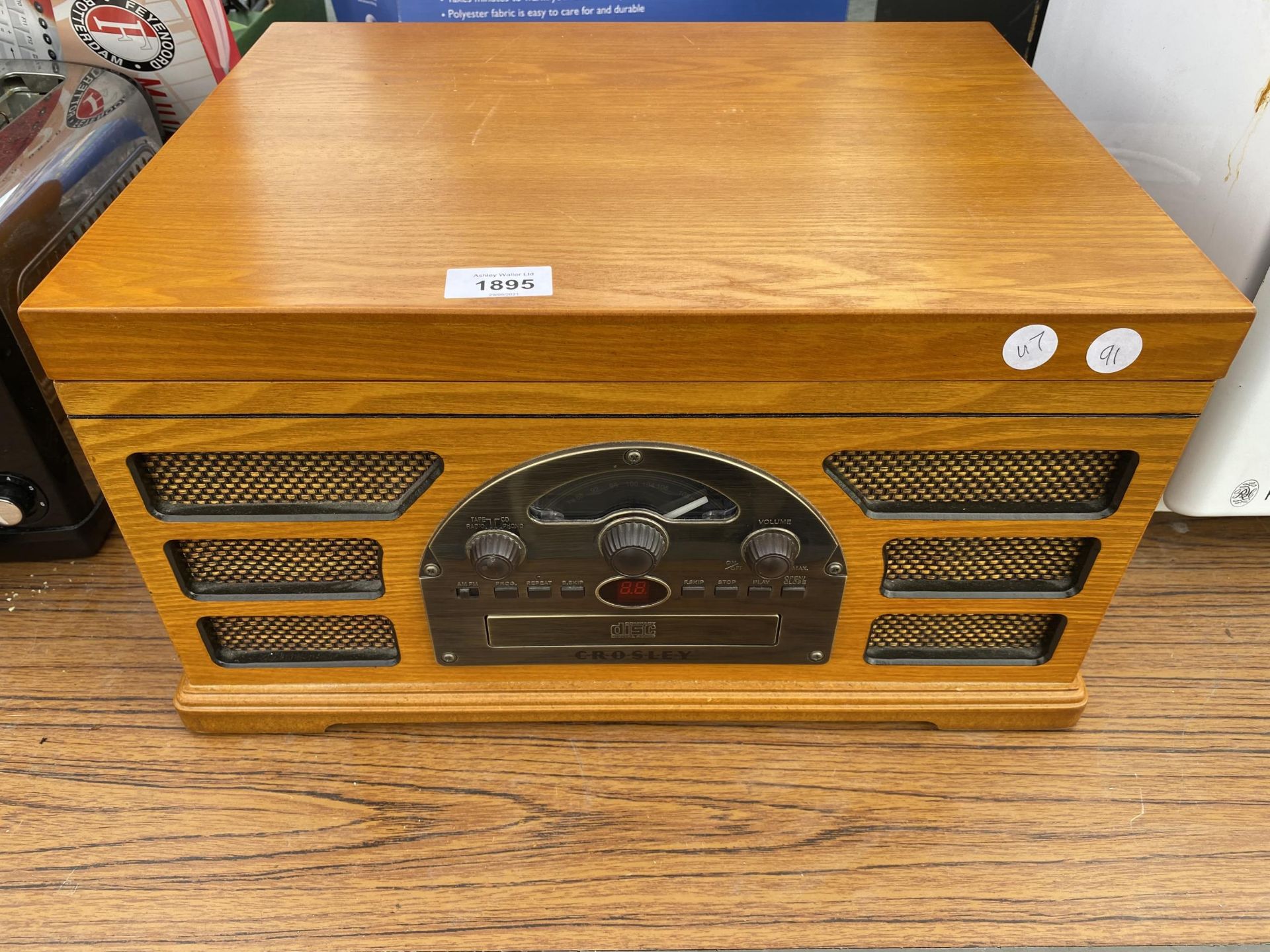 A CROSLEY RECORD PLAYER WITH WOODEN CASING