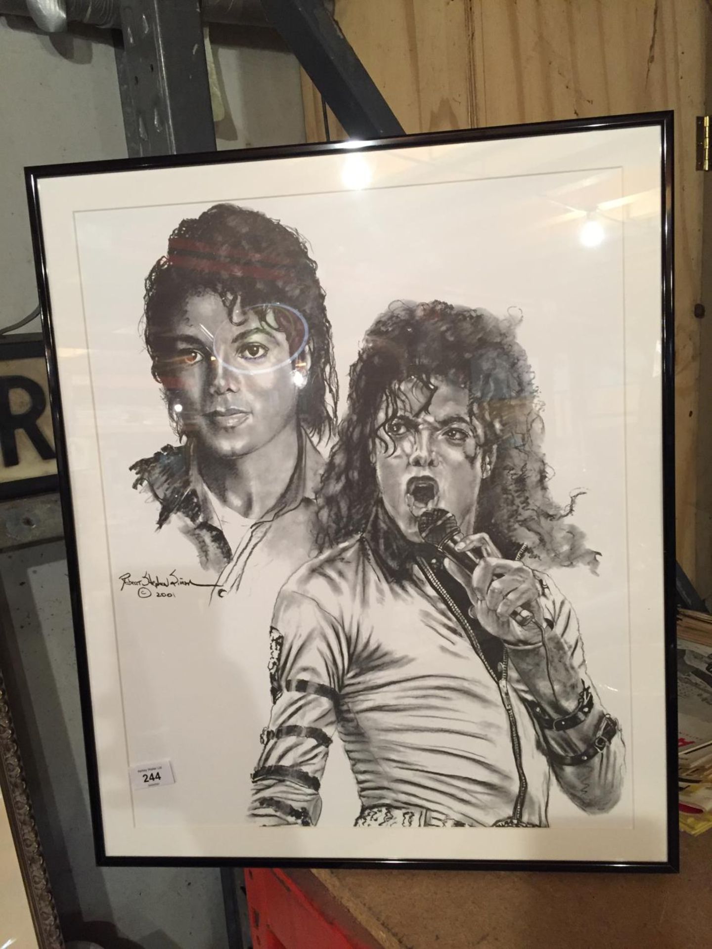 A FRAMED PRINT OF A PORTRAIT OF MICHAEL JACKSON