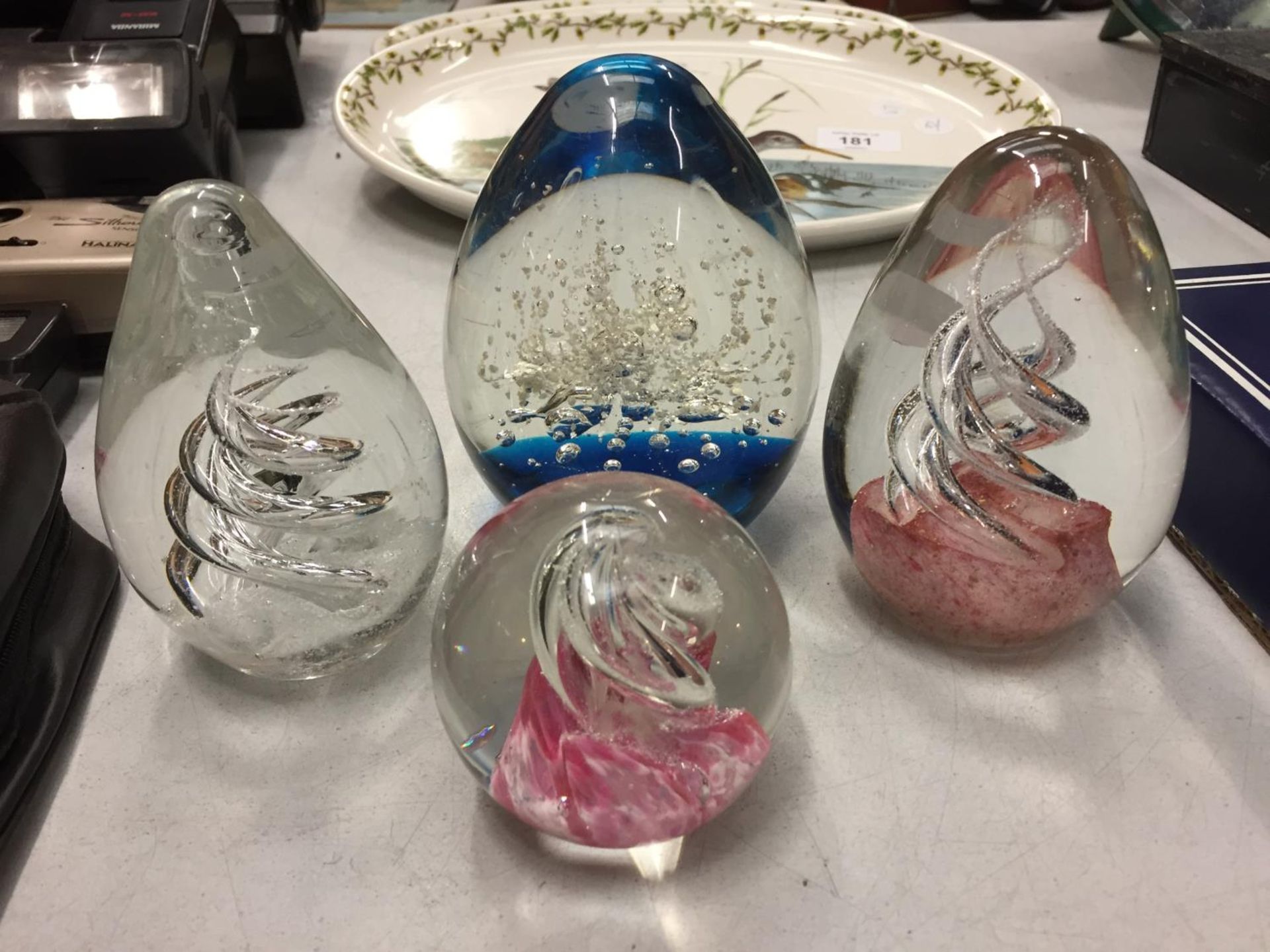 FOUR DECORATIVE GLASS PAPERWEIGHTS
