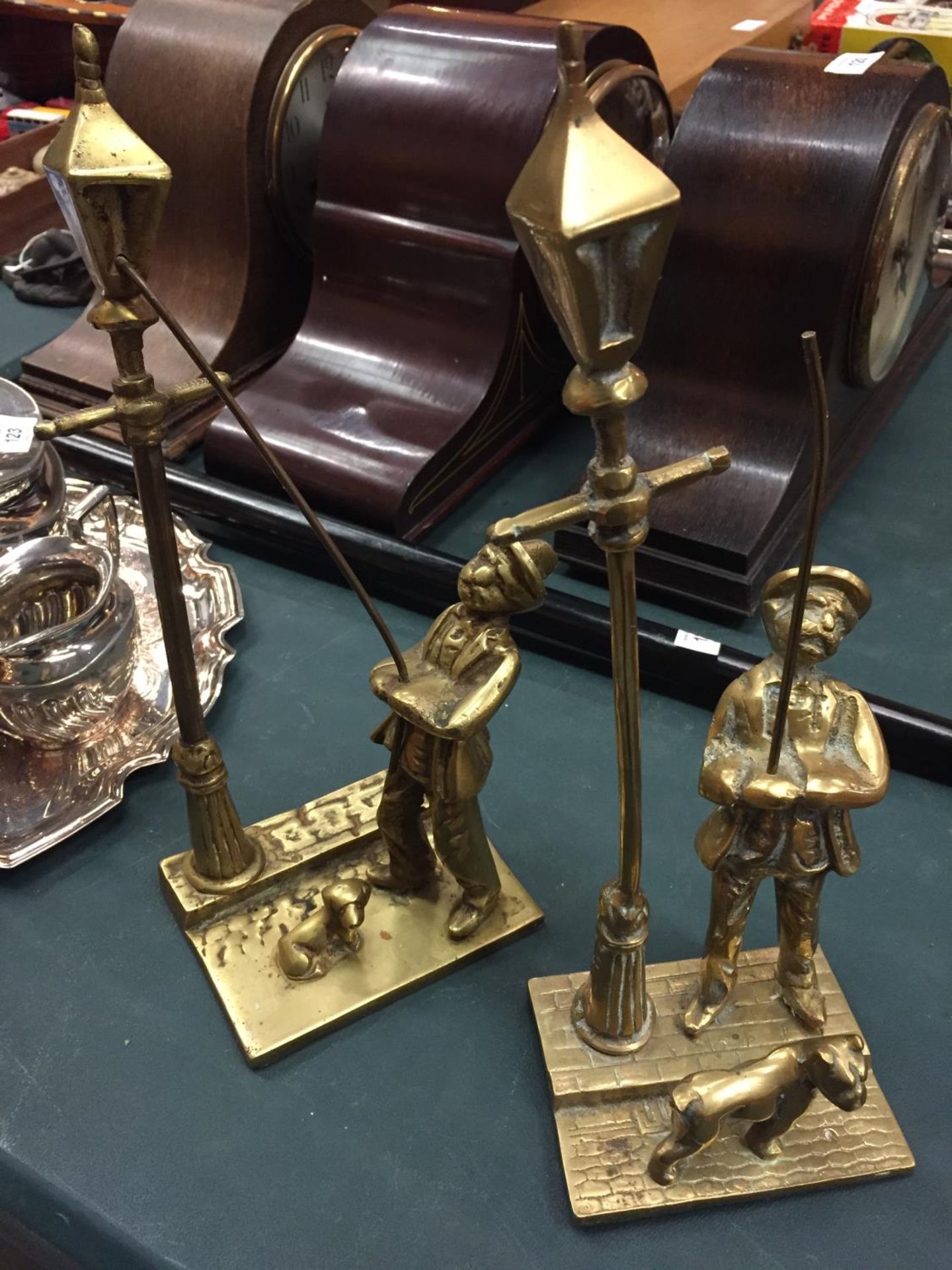 TWO BRASS FIGURES OF STREETLAMP LIGHTERS WITH DOGS