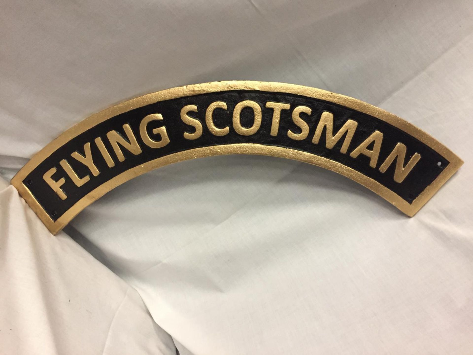 A CAST IRON FLYING SCOTSMAN SIGN