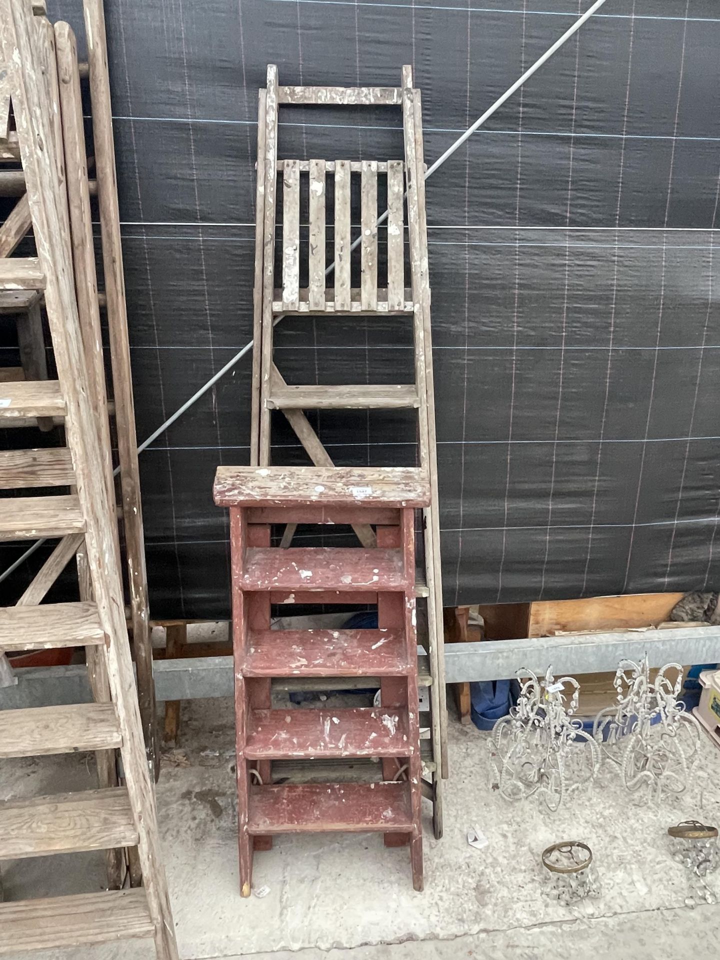 A VINTAGE FIVE RUNG WOODEN STEP LADDER AND A FURTHER FOUR RUNG WOODEN STEP LADDER