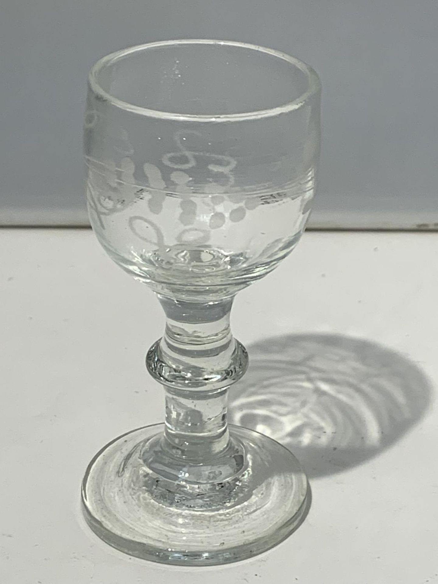 A 19TH CENTURY LIQUER GLASS WITH LATER ETCHING AND PONTIL MARK