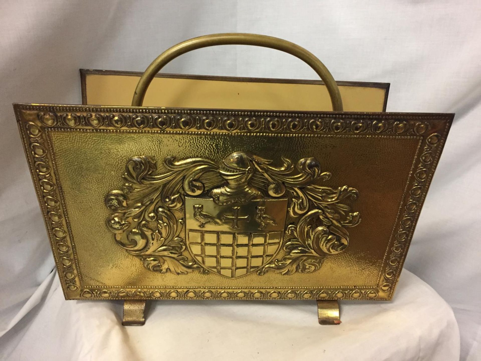 A VINTAGE BRASS MAGAZINE RACK