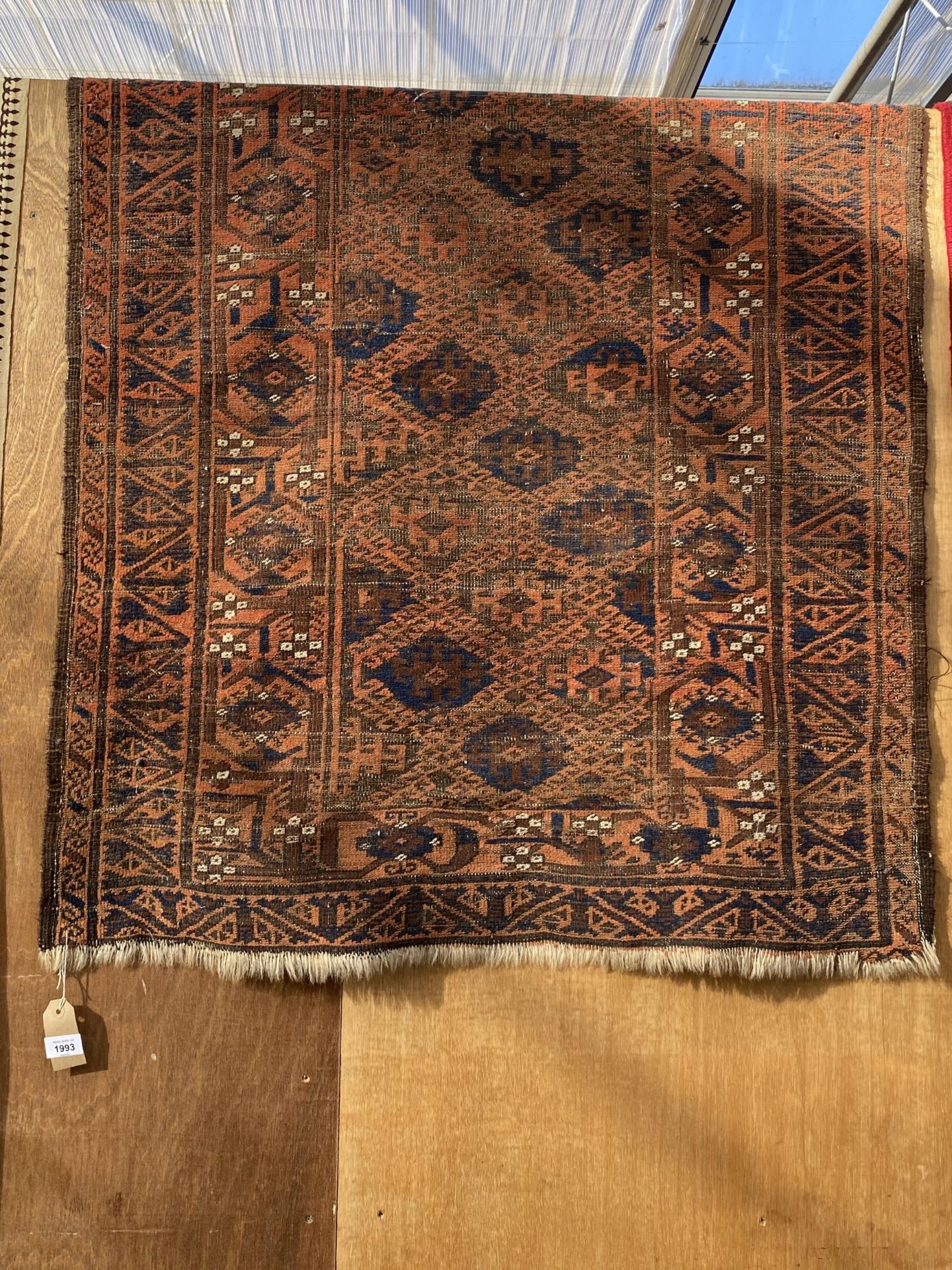 AN ORANAGE AND BLUE PATTERNED RUG