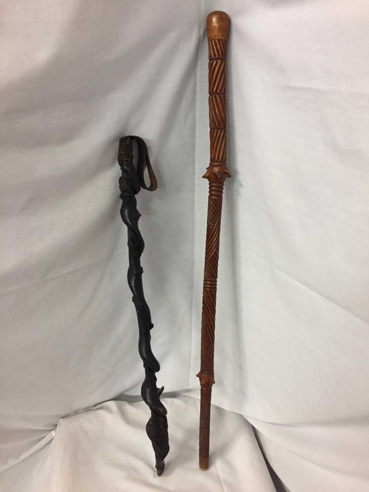 A SHILLELAGH IRISH BLACKTHORN STICK AND AN ORIENTAL WOODEN STICK