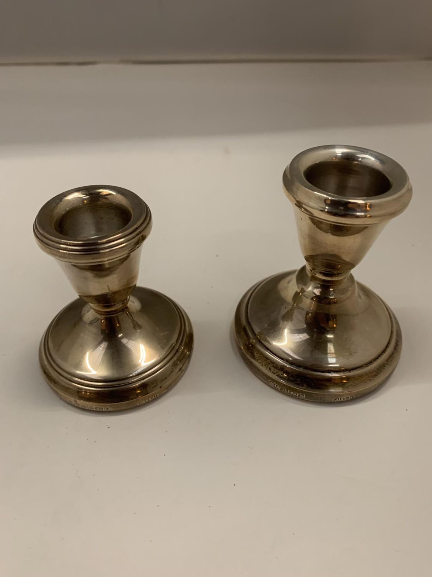 TWO HALLMARKED BIRMINGHAM SILVER WEIGHTED CANDLESTICK HOLDERS APPROXIMATELY 7CM HIGH