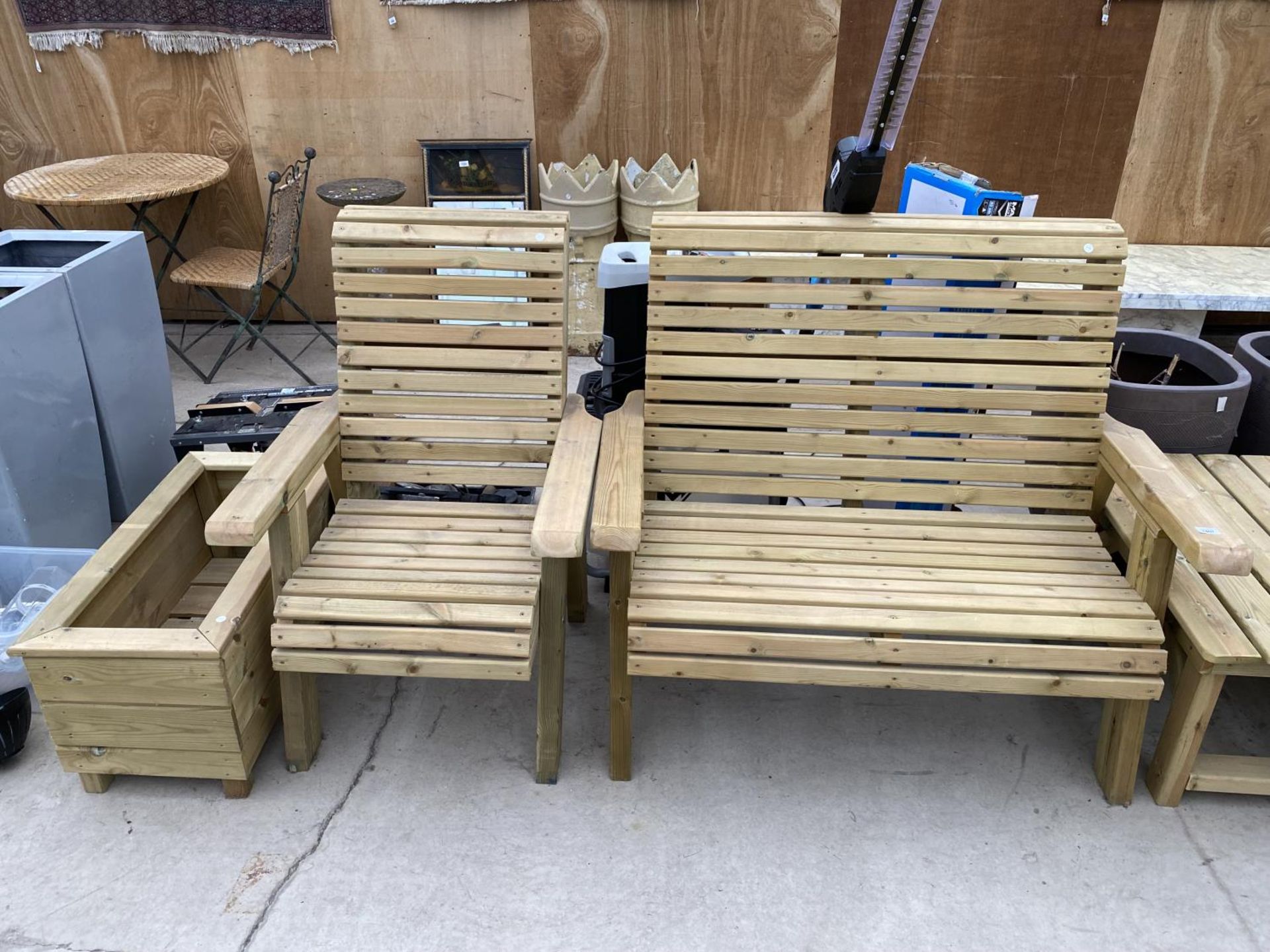 A WOODEN GARDEN FURNITURE SET TO INCLUDE A TWO SEATER BENCH, A CHAIR AND A PLANTER