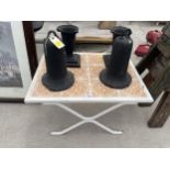 A RETRO TILE TOP TABLE AND TWO BELL SHAPED CAST IRON POTS