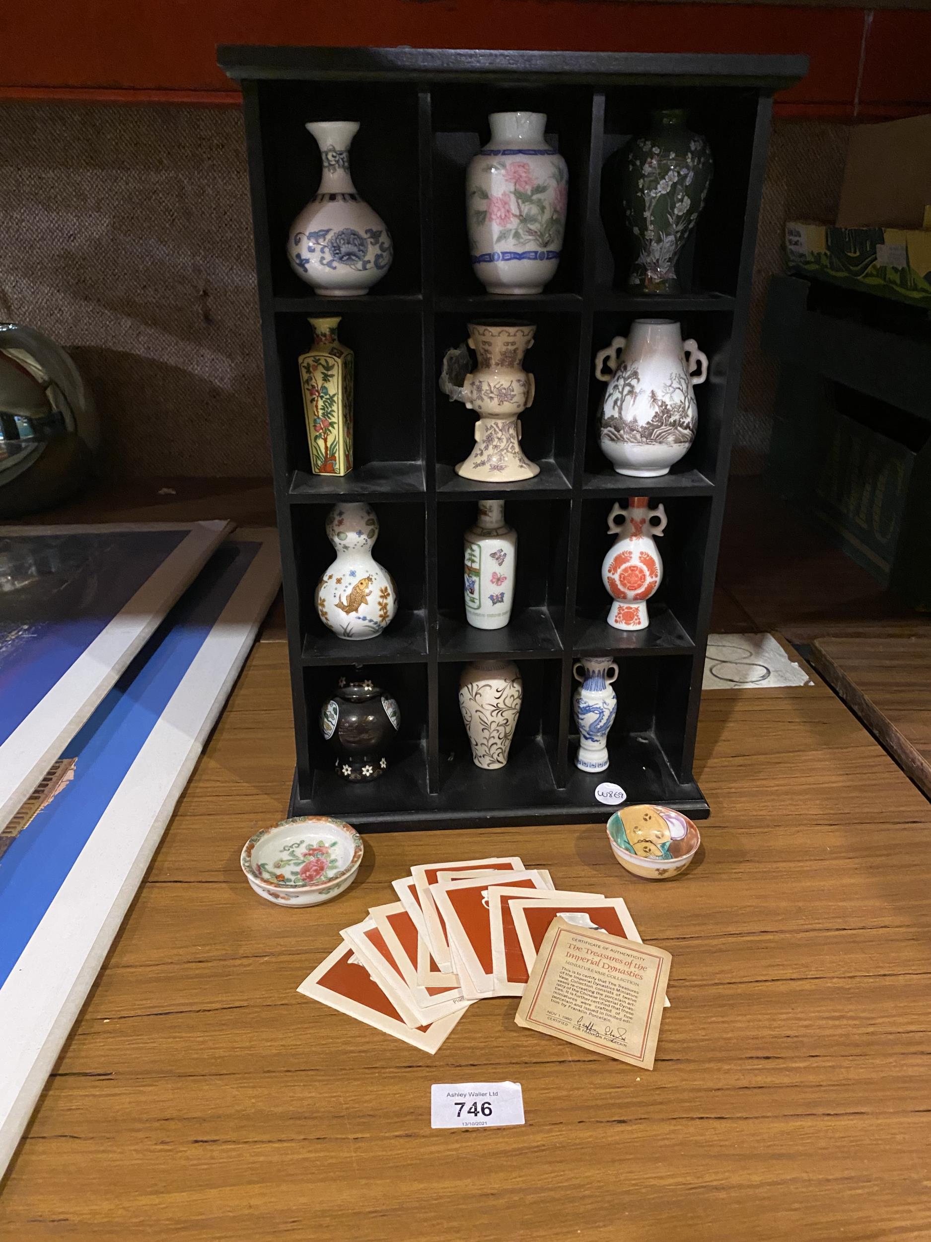 A SMALL DISPLAY CABINET WITH MINIATURE ORIENTAL STYLE VASES. ALSO INCLUDES INFORMATION CARDS AND TWO