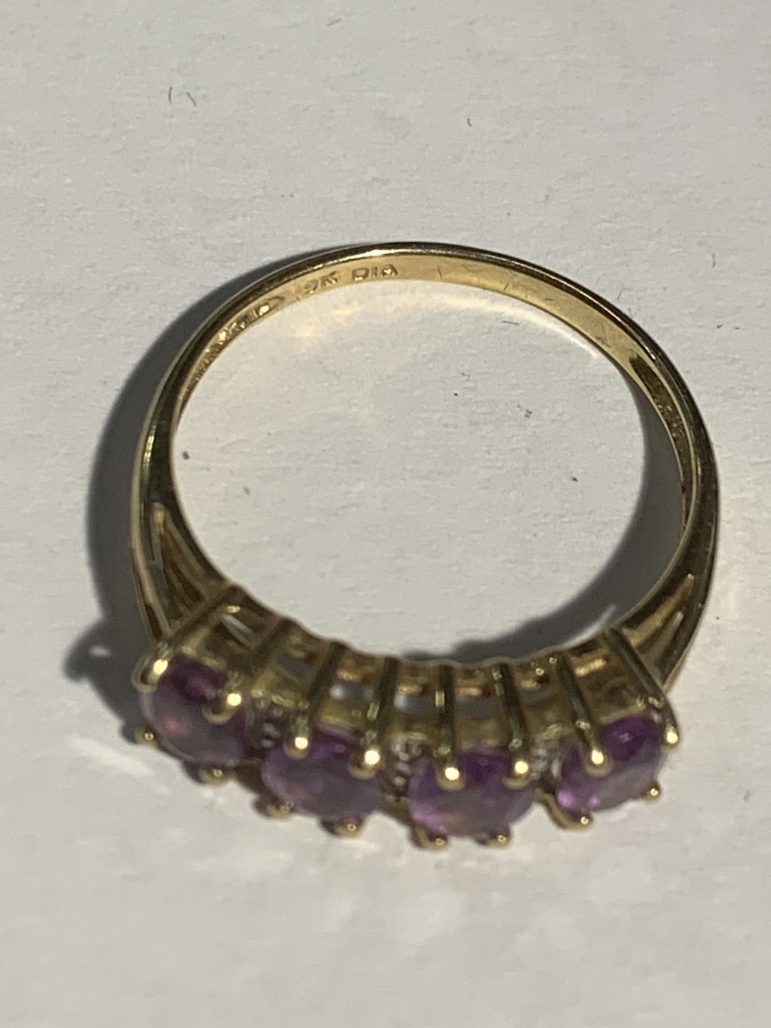 A 9 CARAT GOLD RING WITH FOUR IN LINE PURPLE STONES SIZE P GROSS WEIGHT 2.1 GRAMS - Image 3 of 3
